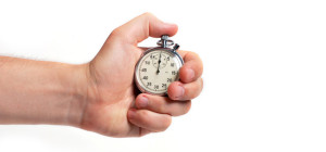 Man's hand holding stopwatch